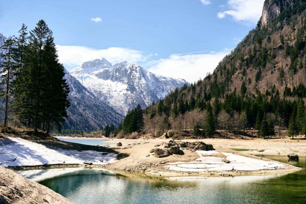 Frühlingshafte Alpenlandschaft mit Schmelzwasser, Bergsee und schneebedeckten Gipfeln im Alpen-Adria-Raum – ruhige Landschaftsfotografie von Florian Schulte mit natürlichen Lichtstimmungen und alpiner Atmosphäre.